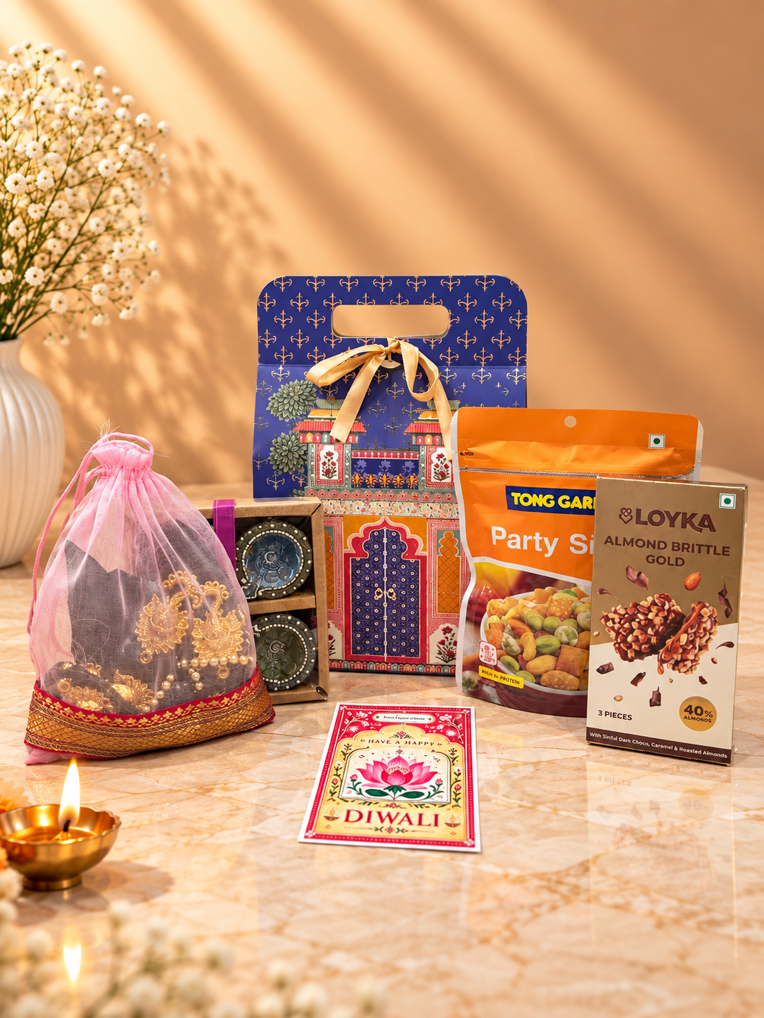 Open Royal Blue Heritage Diwali hamper with Open Secret snacks, Loyka almond brittle, clay diyas and festive toran