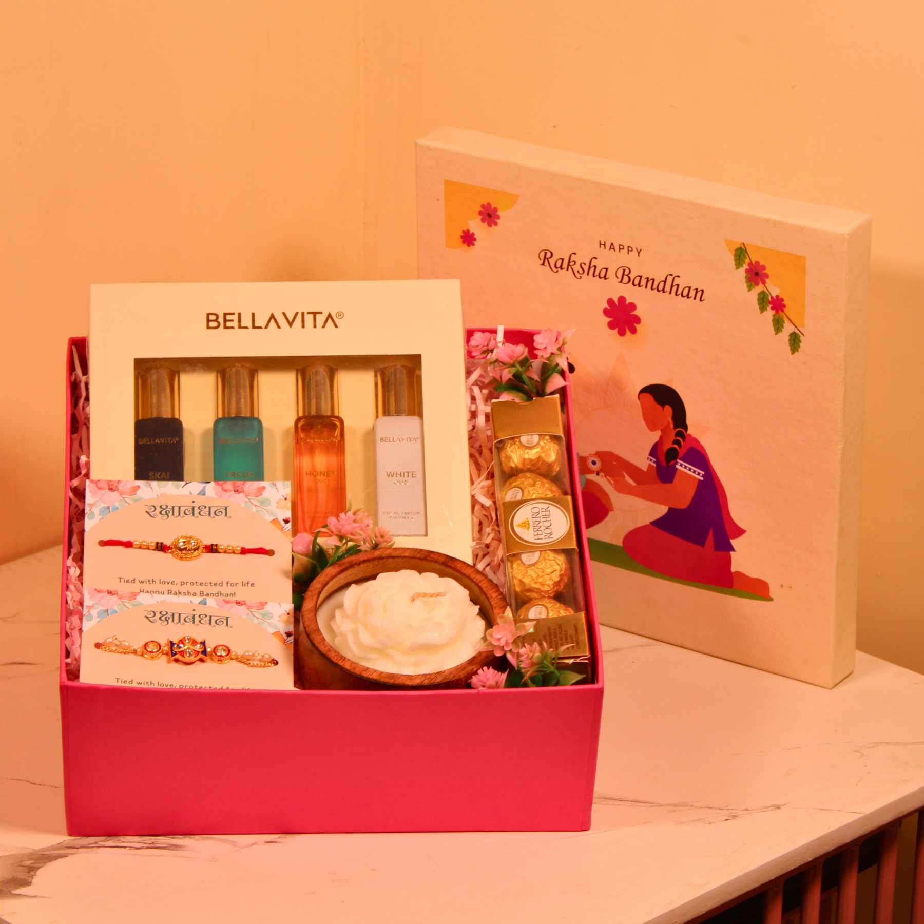 Rakhi Gift Hamper for Bhaiya Bhabhi – Pink Box with Couple Rakhi, Perfume Set, Chocolates & Candle