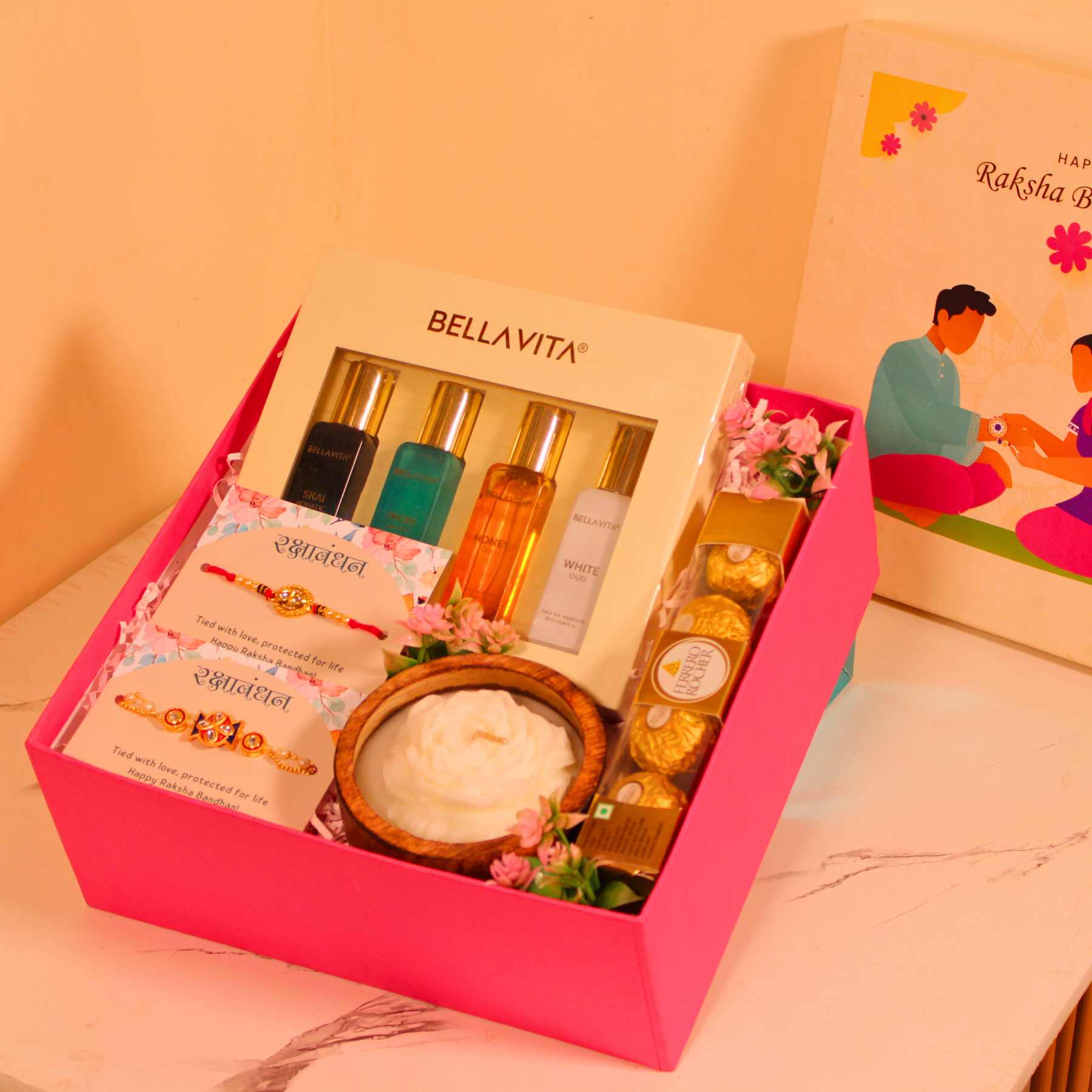 Rakhi Gift Hamper for Bhaiya Bhabhi – Pink Box with Couple Rakhi, Perfume Set, Chocolates & Candle