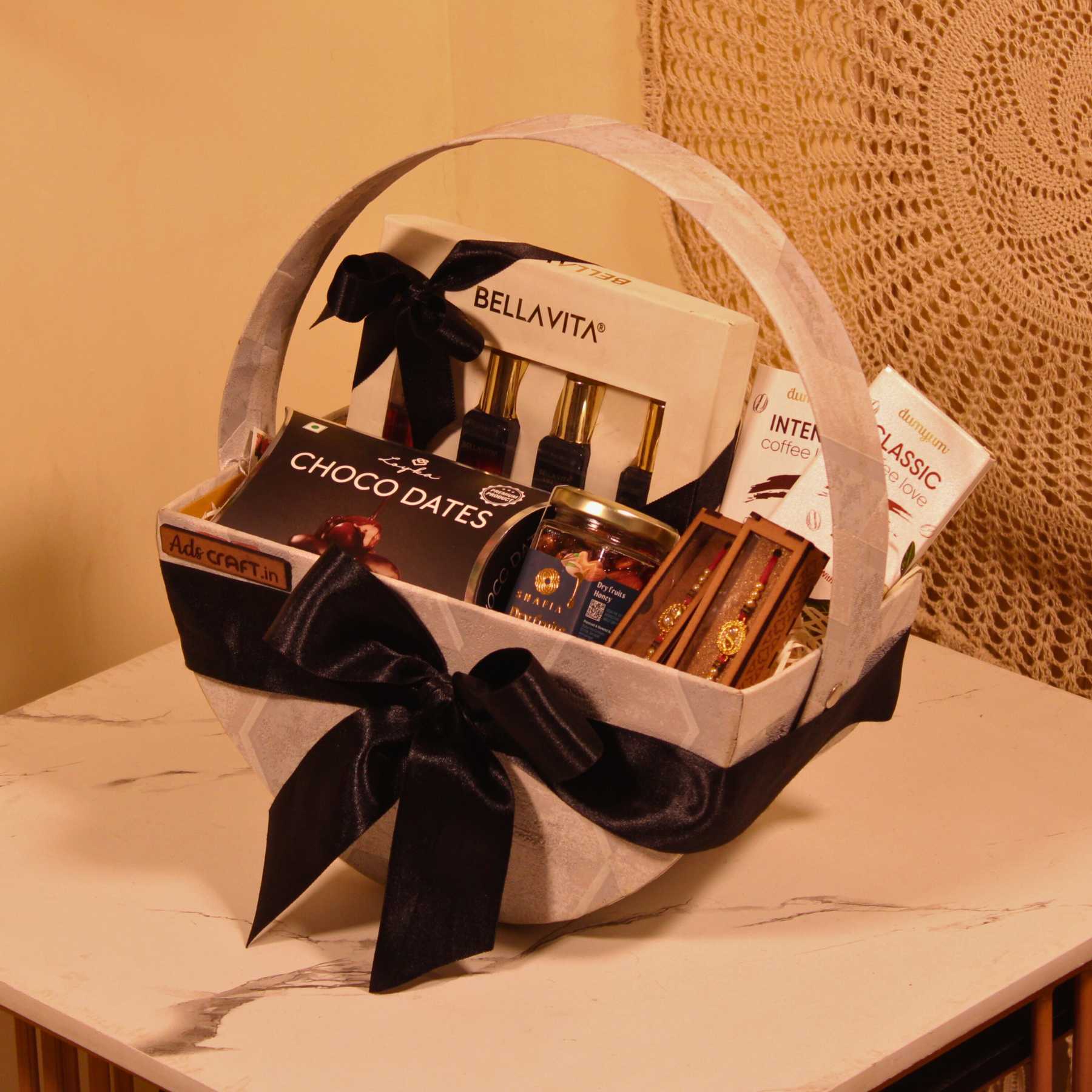 Luxury Rakhi couple gift hamper featuring perfume set, chocolates, dry fruits, and designer rakhis.

