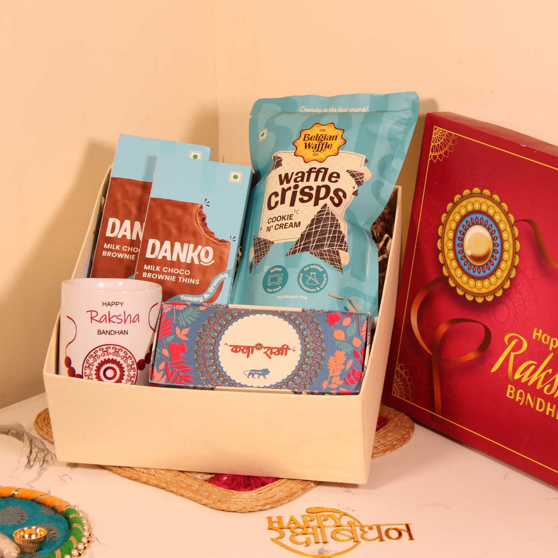 Rakhi Gift Hamper for Brother – Waffle Crisps, Danko Cookies, Premium Rakhi & Mug in Special Box