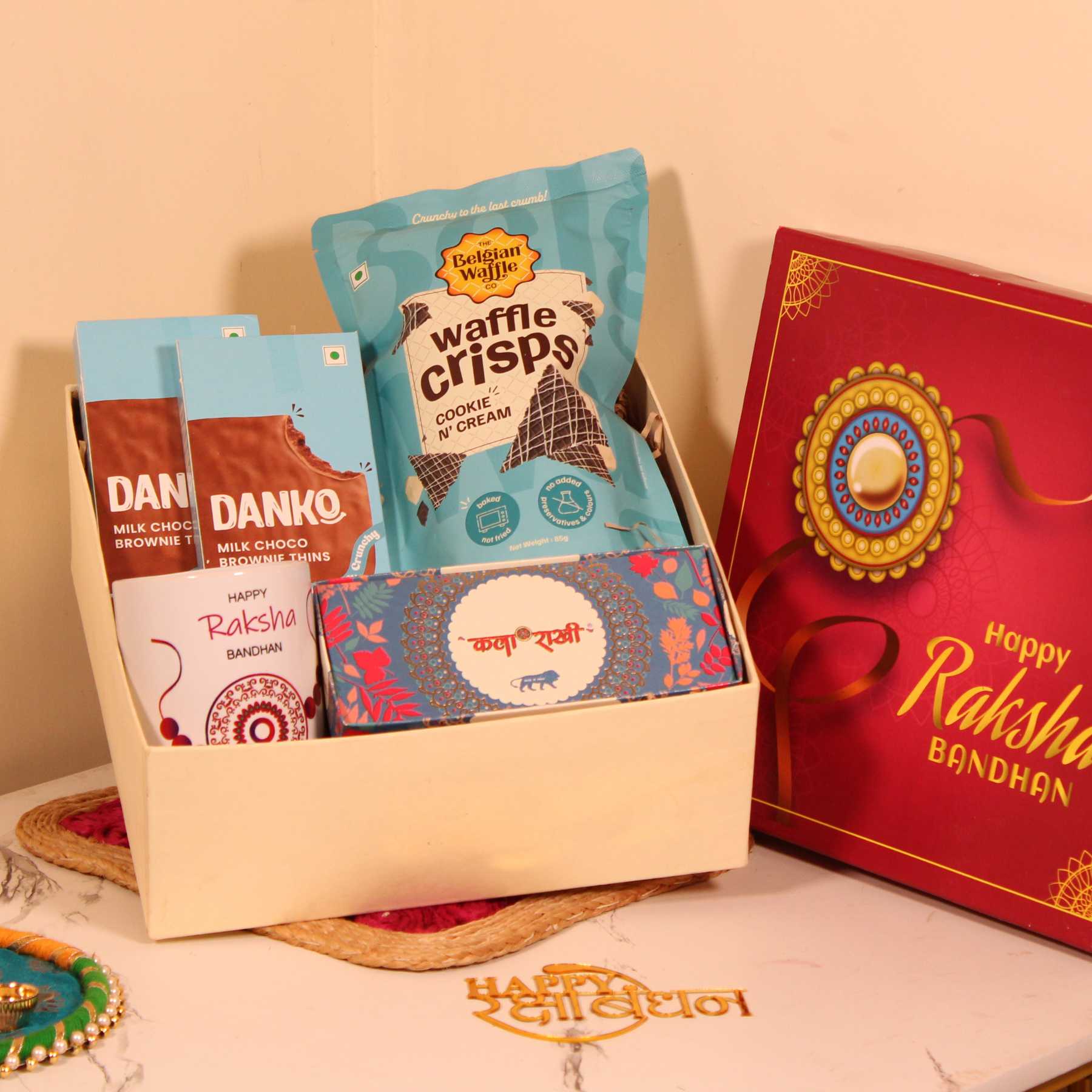 Rakhi Gift Hamper for Brother – Waffle Crisps, Danko Cookies, Premium Rakhi & Mug in Special Box