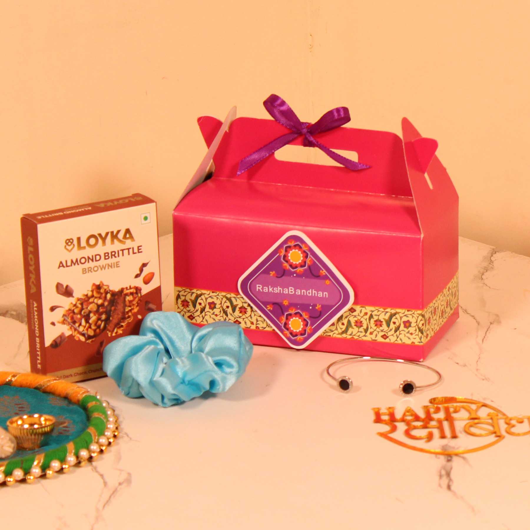Budget-Friendly Rakhi Hamper for Her – Custom Box with Loyka Brittle, Scrunchie & Bracelet