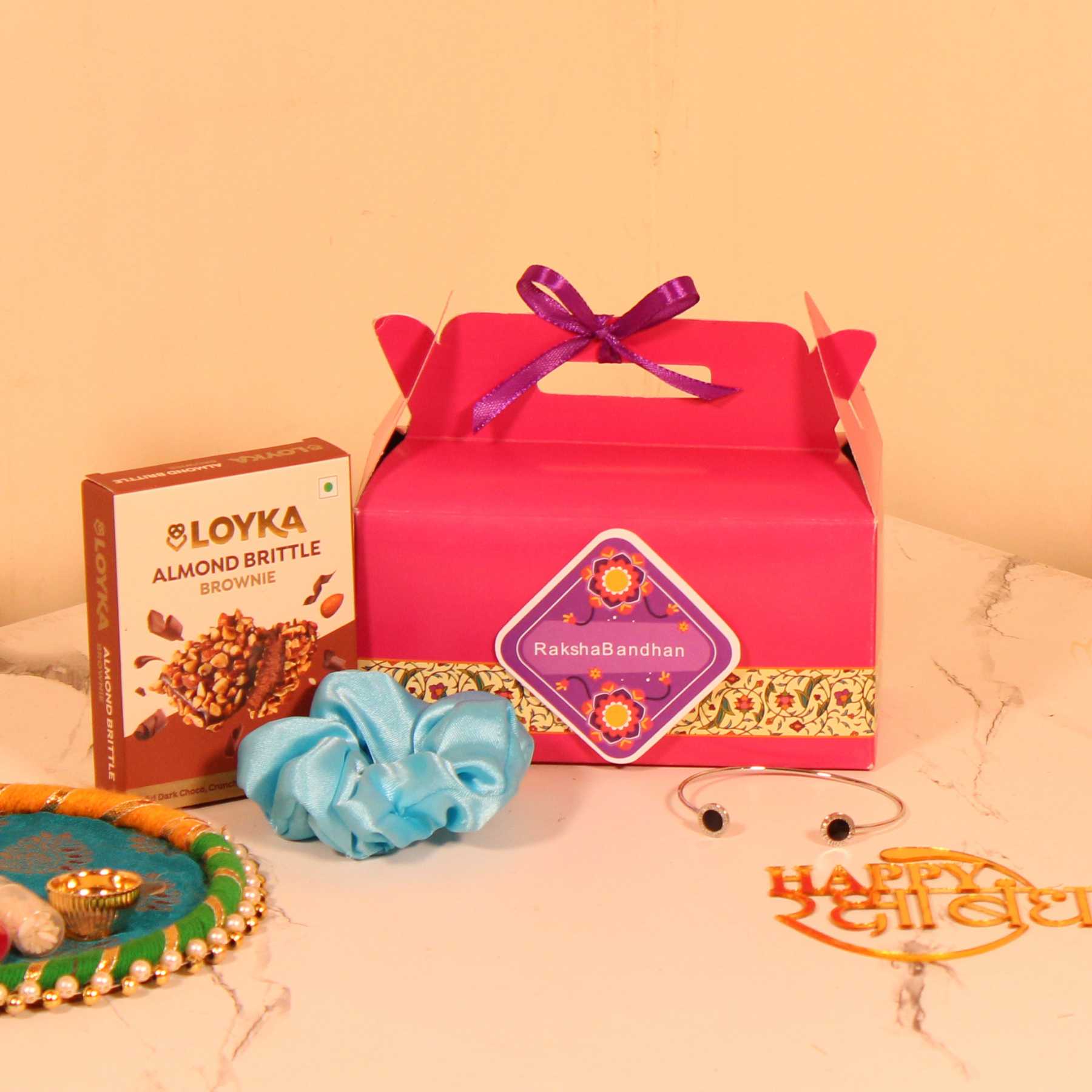 Budget-Friendly Rakhi Hamper for Her – Custom Box with Loyka Brittle, Scrunchie & Bracelet