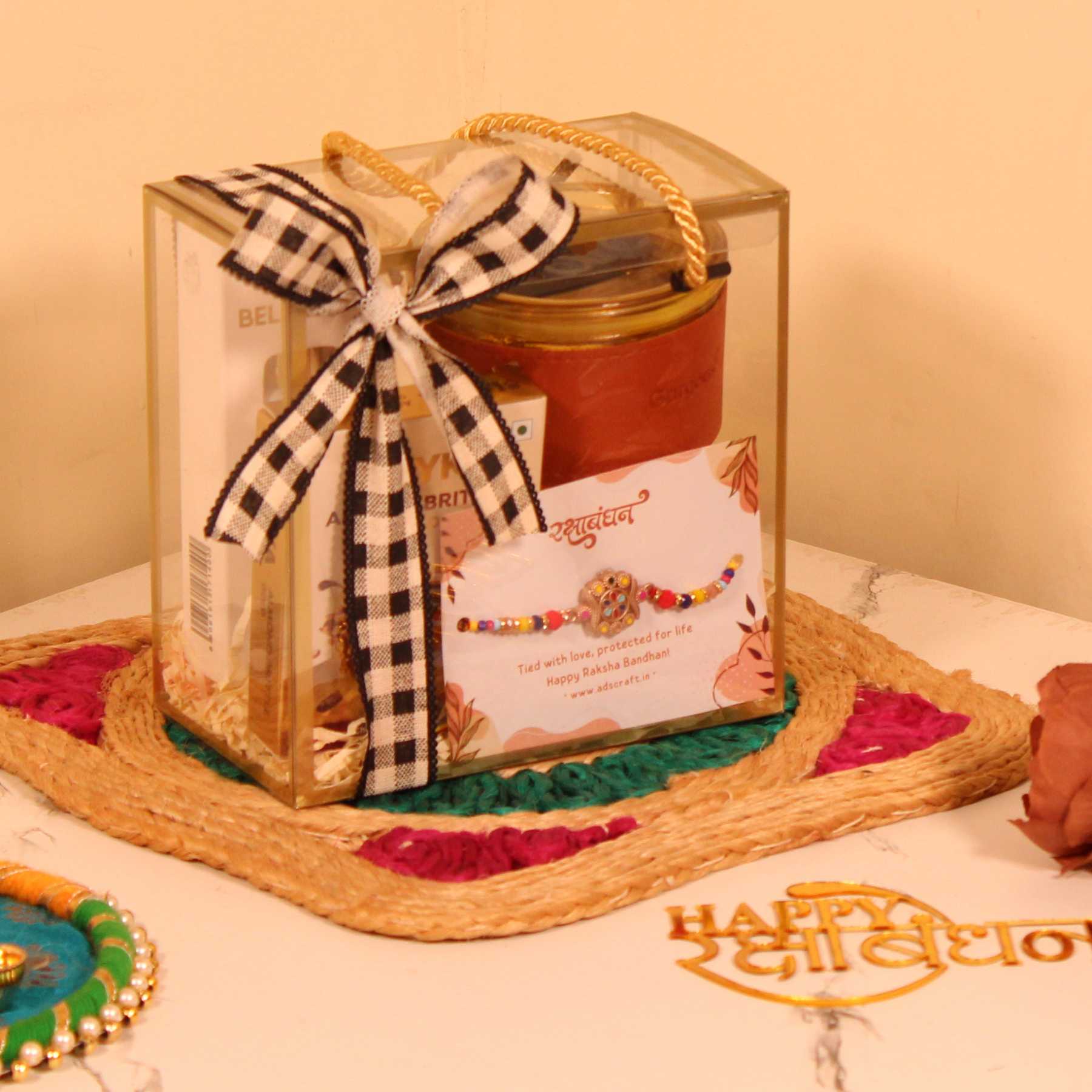 Rakhi Gift Hamper for Him – Premium PVC Bag with Perfume, Coffee Sipper, Rakhi & Almond Brittle