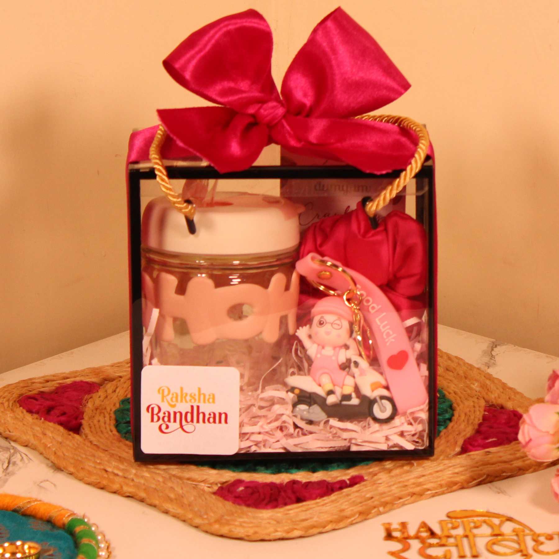 Rakhi Gift Hamper for Her – Pink Box with Sipper, Chocolate, Keychain & Scrunchie