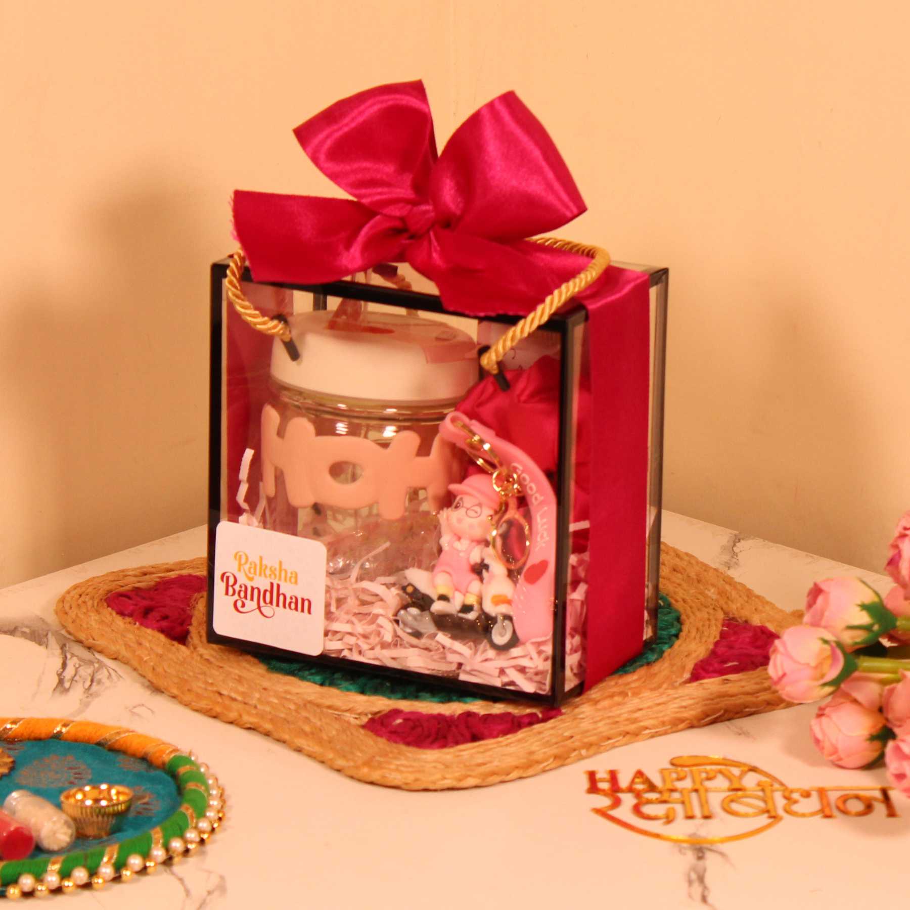 Rakhi Gift Hamper for Her – Pink Box with Sipper, Chocolate, Keychain & Scrunchie