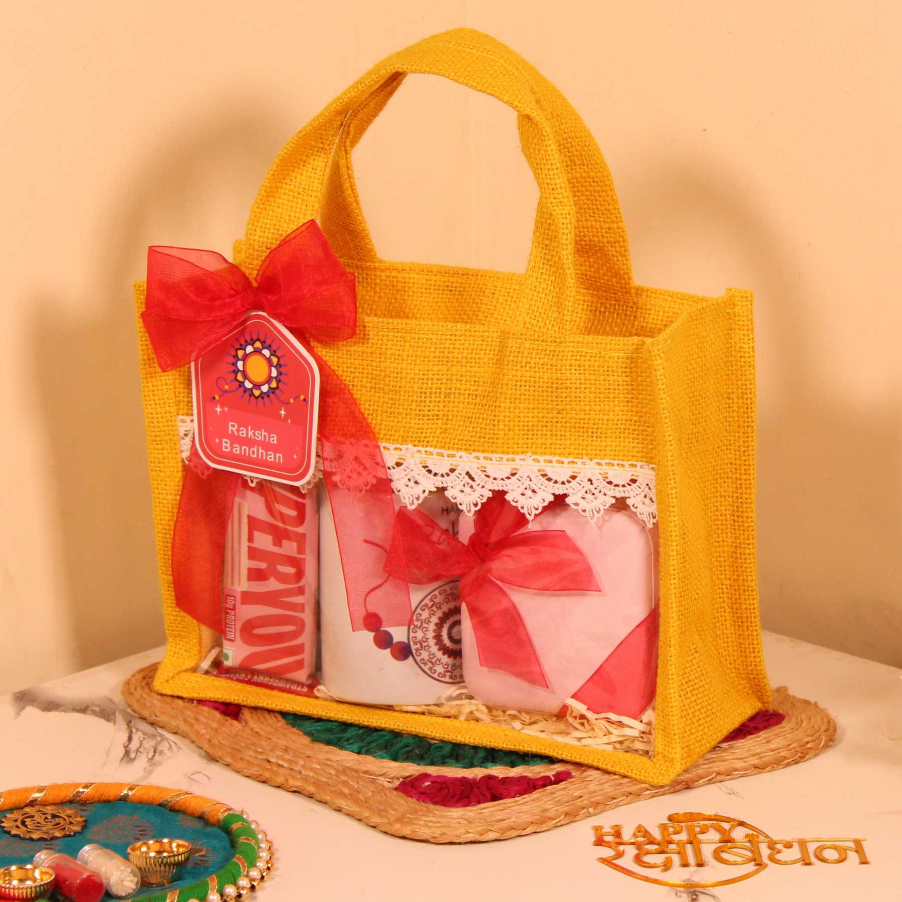 Rakhi Gift Hamper for Her – Yellow Jute Bag with Mug, Jewellery Organizer & Protein Bars