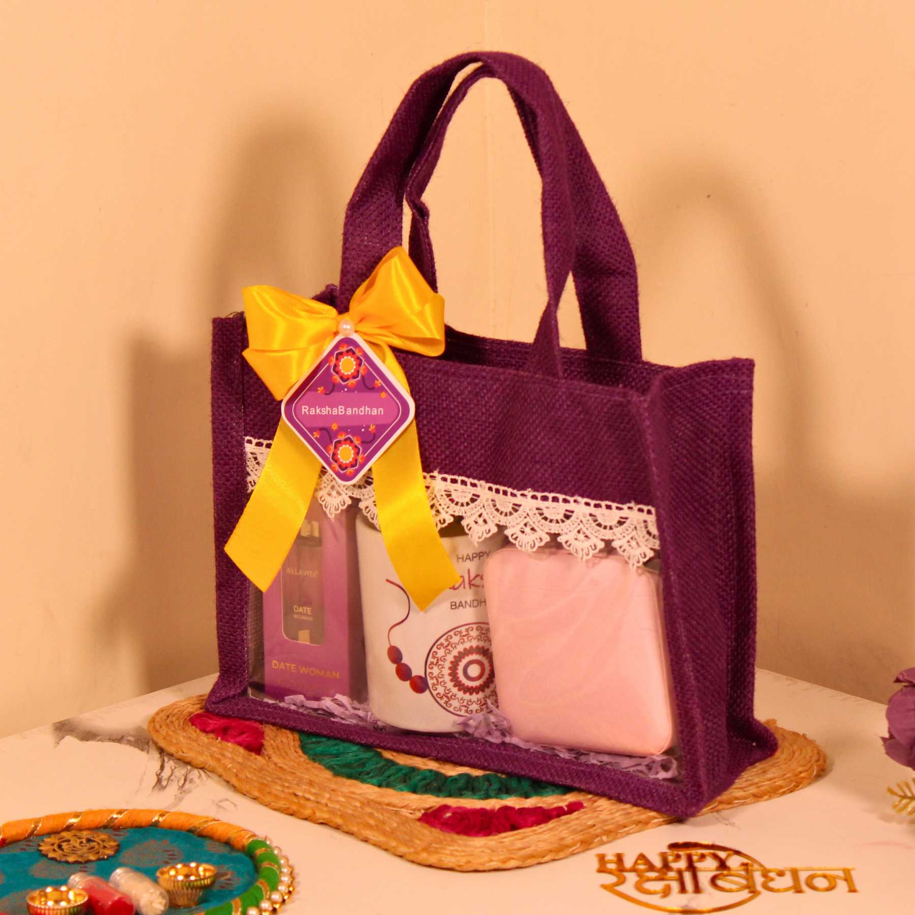 Rakhi Gift Hamper for Her – Purple Jute Bag with Perfume, Mug, Jewellery Organizer & Party Mix