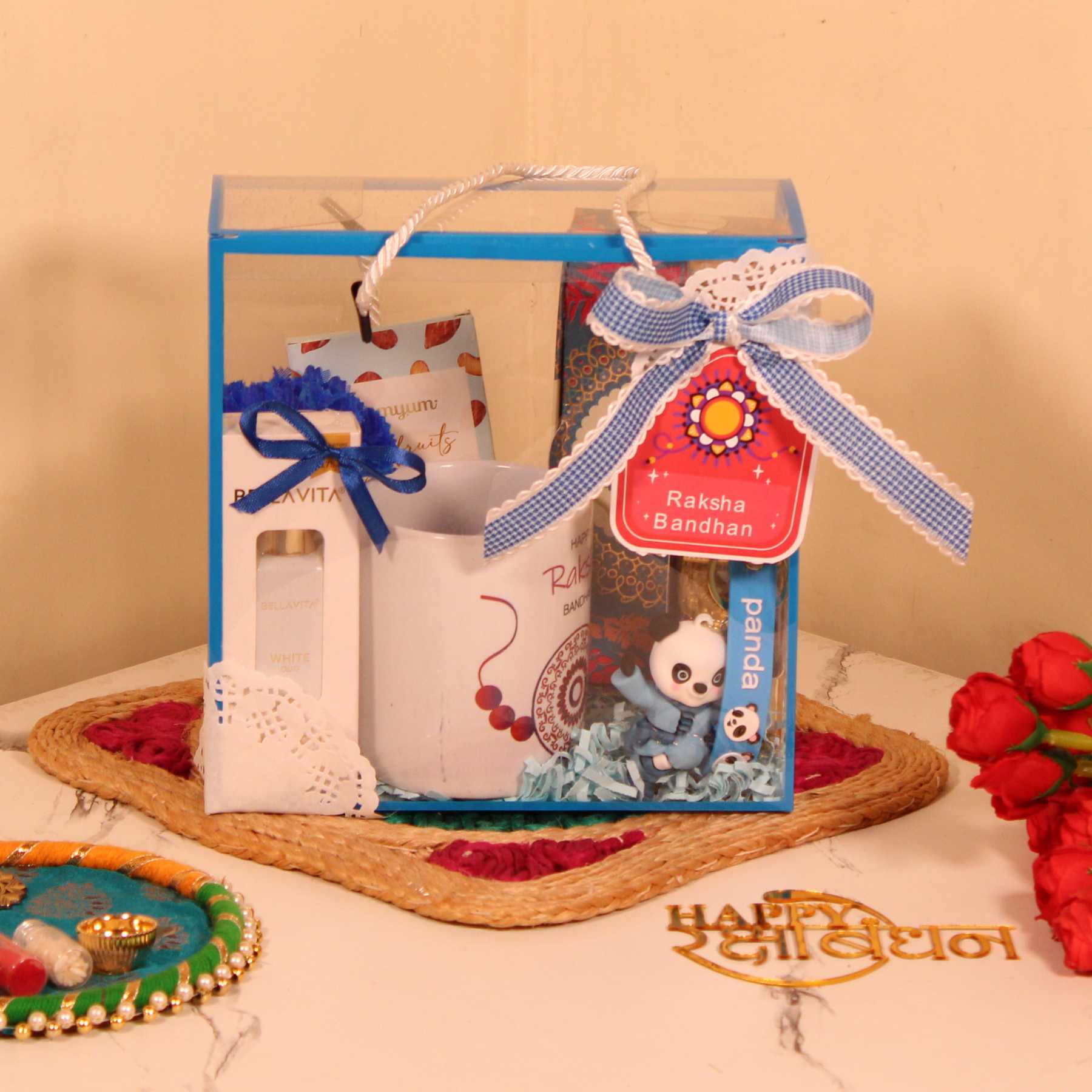 Rakhi Gift Hamper for Brother – Blue PVC Bag with Mug, Perfume, Chocolates & Keychain