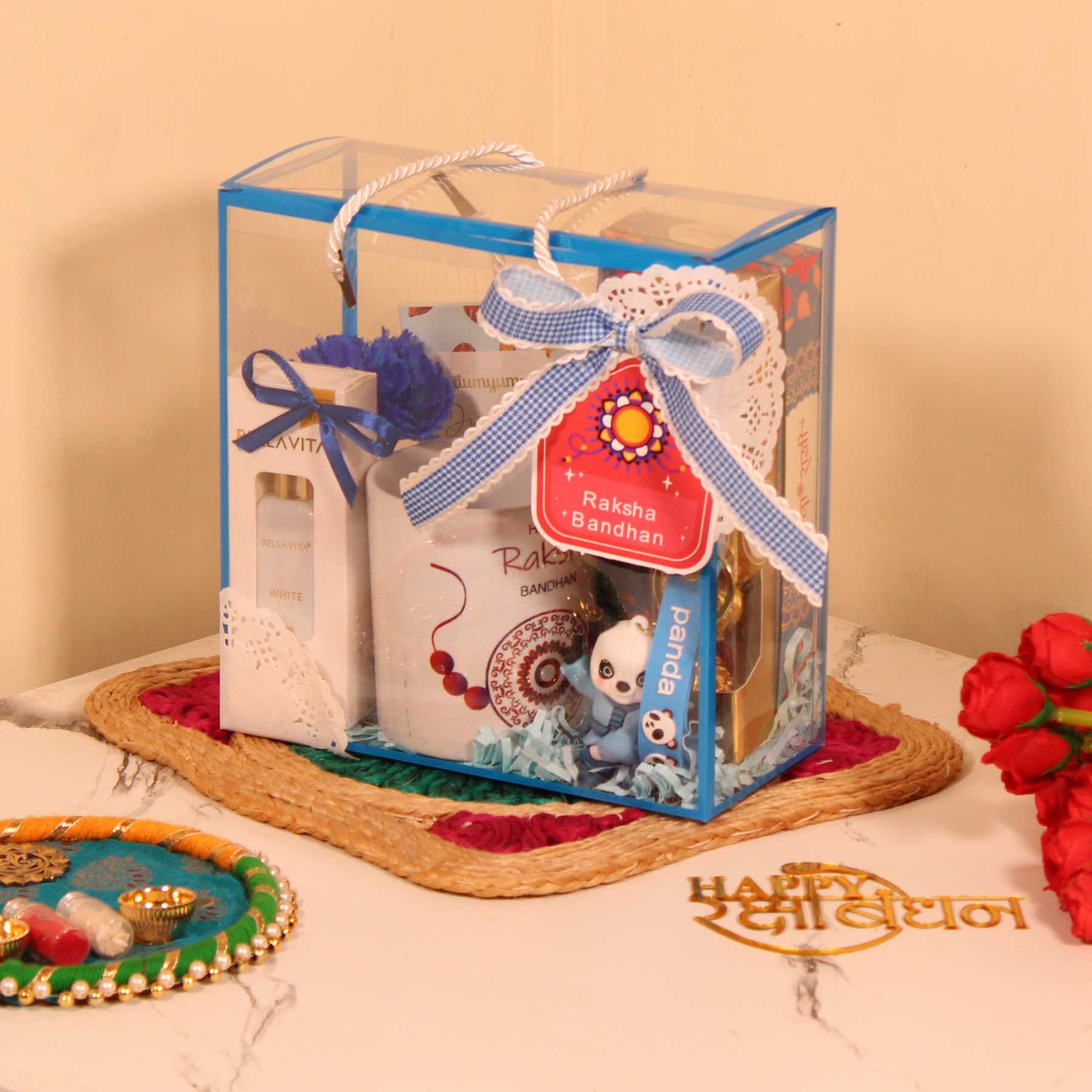 Rakhi Gift Hamper for Brother – Blue PVC Bag with Mug, Perfume, Chocolates & Keychain