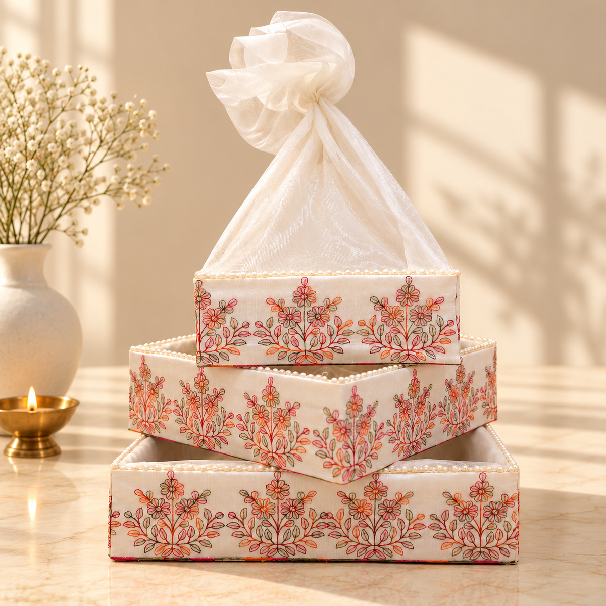 Luxury ivory wedding trousseau nesting tray set of 3 with coral embroidery, pearl edging and sheer net cover in India