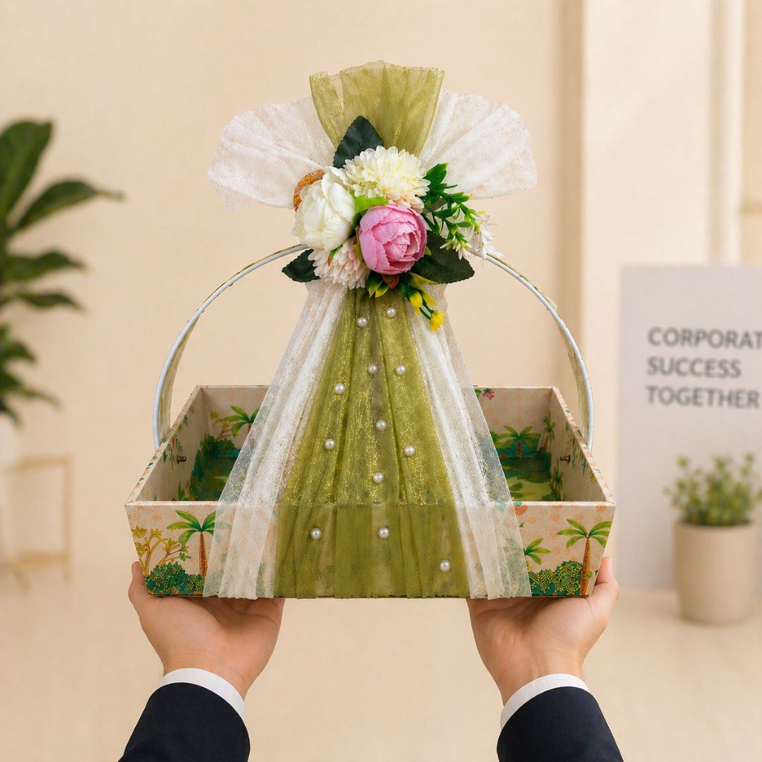 Floral arrangement in a decorative box held by hands against a neutral background