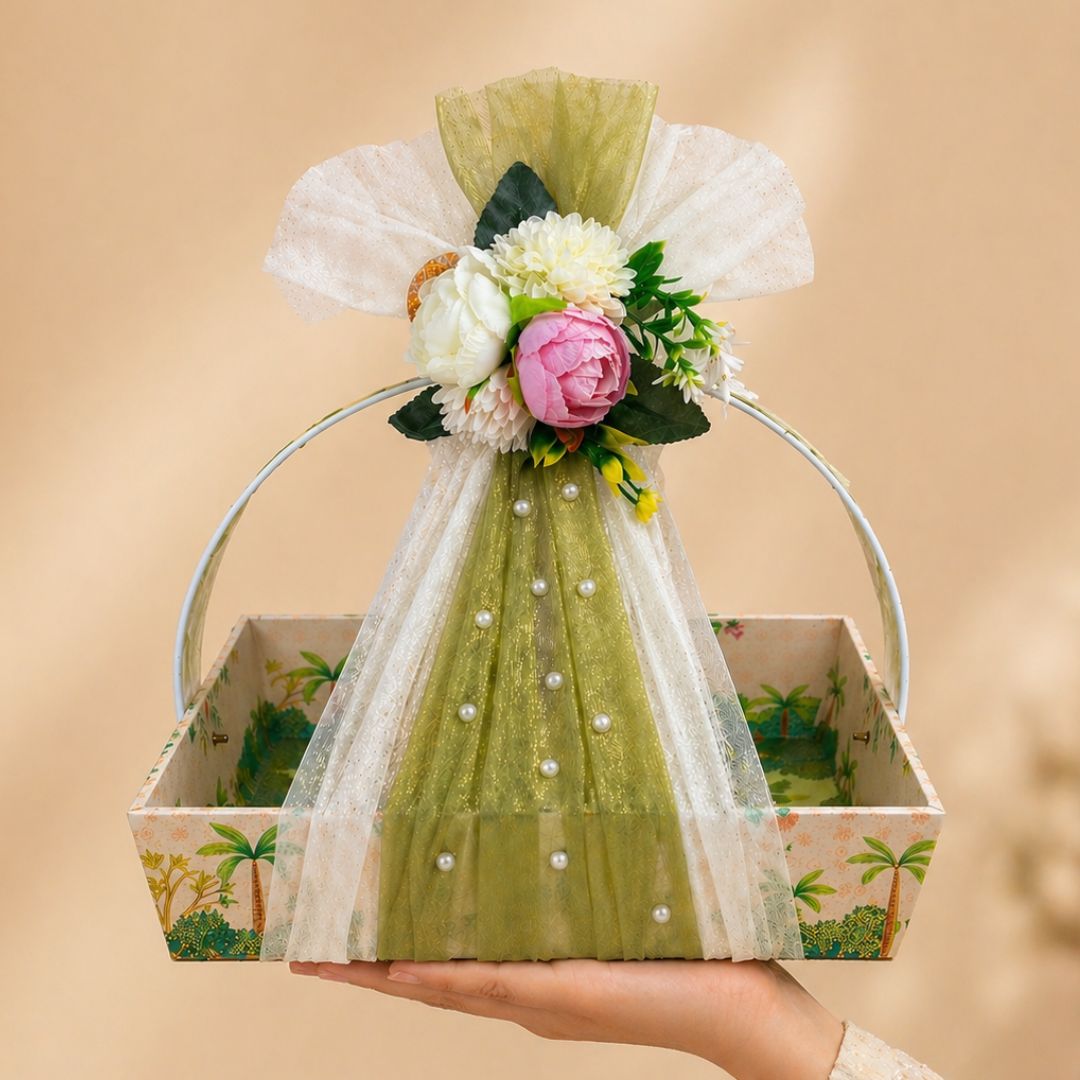Decorative flower arrangement in a box with a green dress-like cover on a beige background