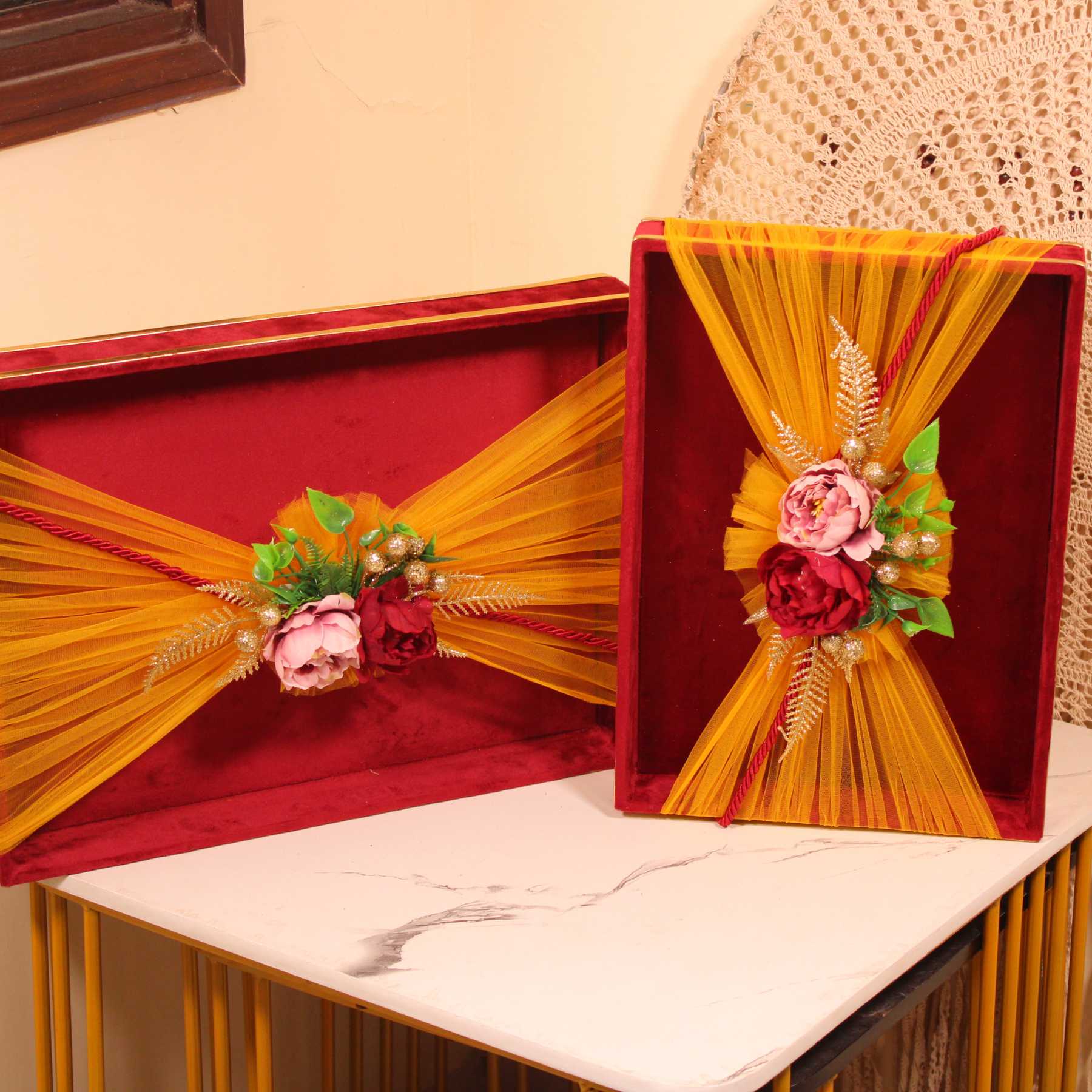 Ready-to-use velvet trays for festive gifting and return hampers with flower and net embellishments