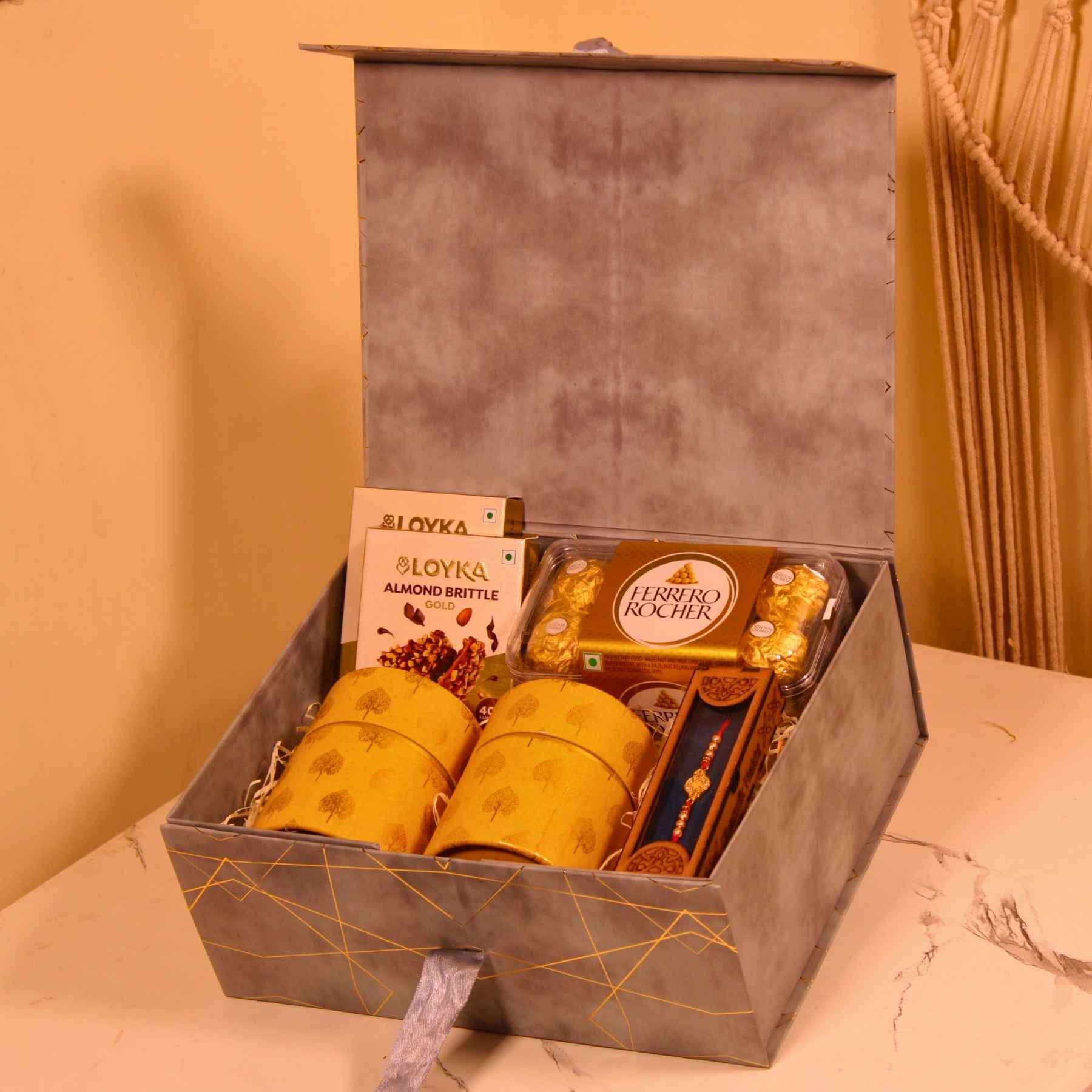 Grey Luxe Rakhi Hamper – Almond Brittle, Rakhi & Chocolate Combo in Magnetic Box