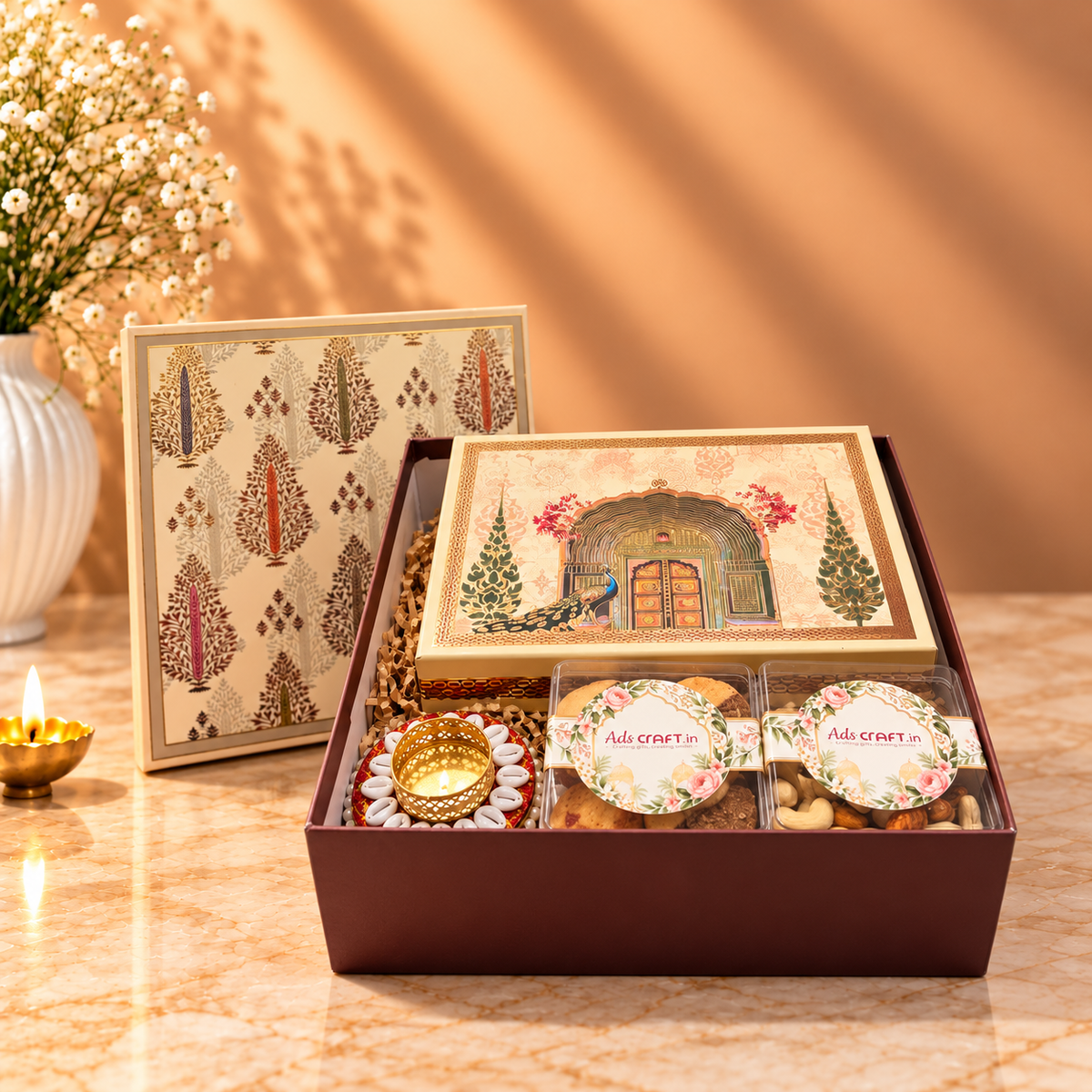 Top Bottom Diwali hamper box with branded cashew and almond acrylic containers, assorted sweets and handicraft diya