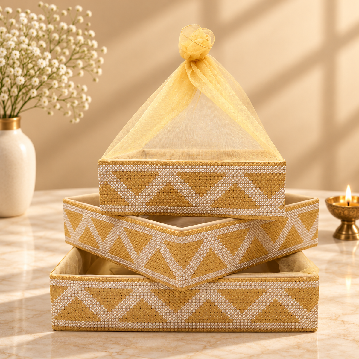 Traditional Gold Chevron woven nesting tray set of 3 with golden sheer net potli cover for festive gifting in India