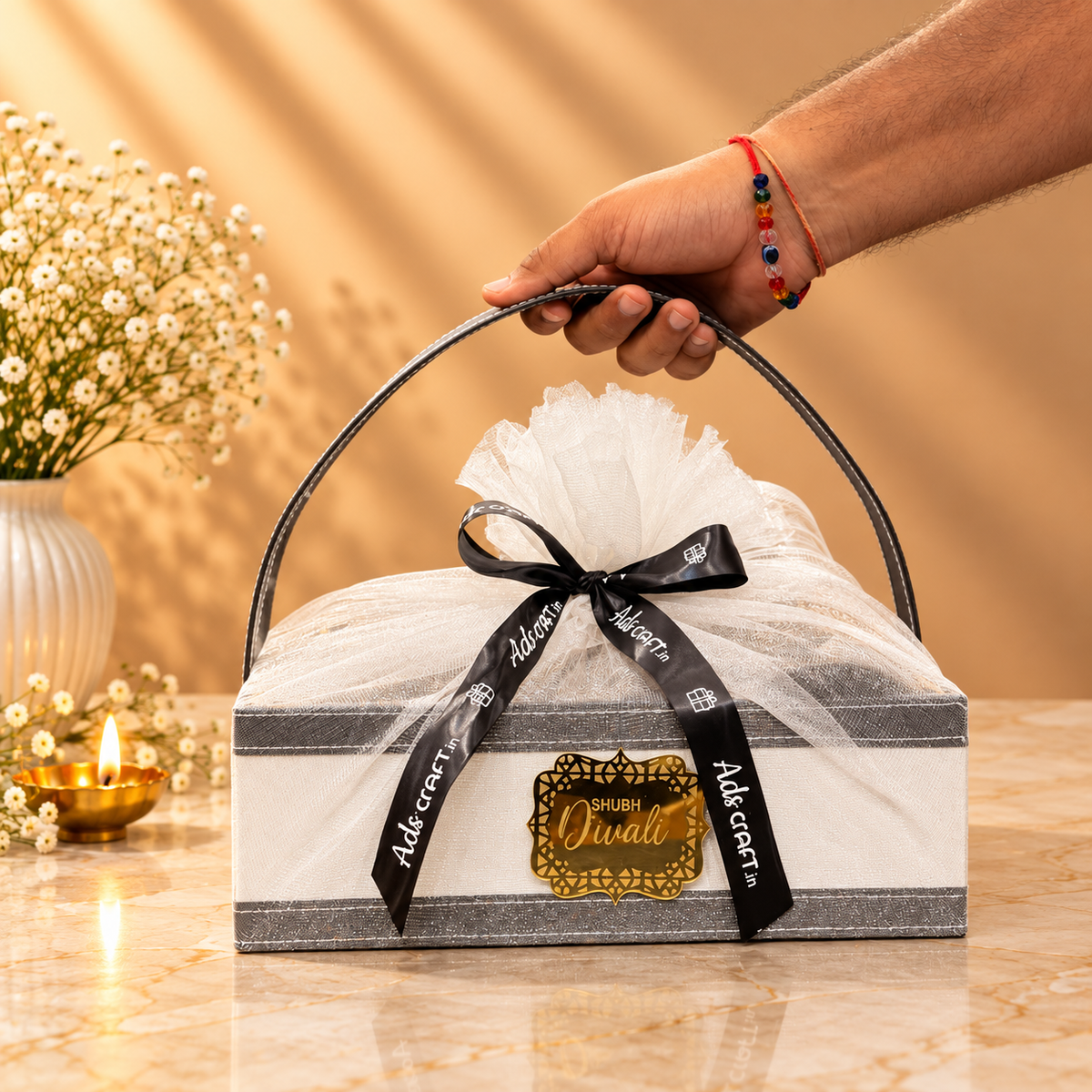 Open Heritage Luxe Diwali hamper with brass serveware, brass diya, Aura Decor candle and Eat Better laddoo