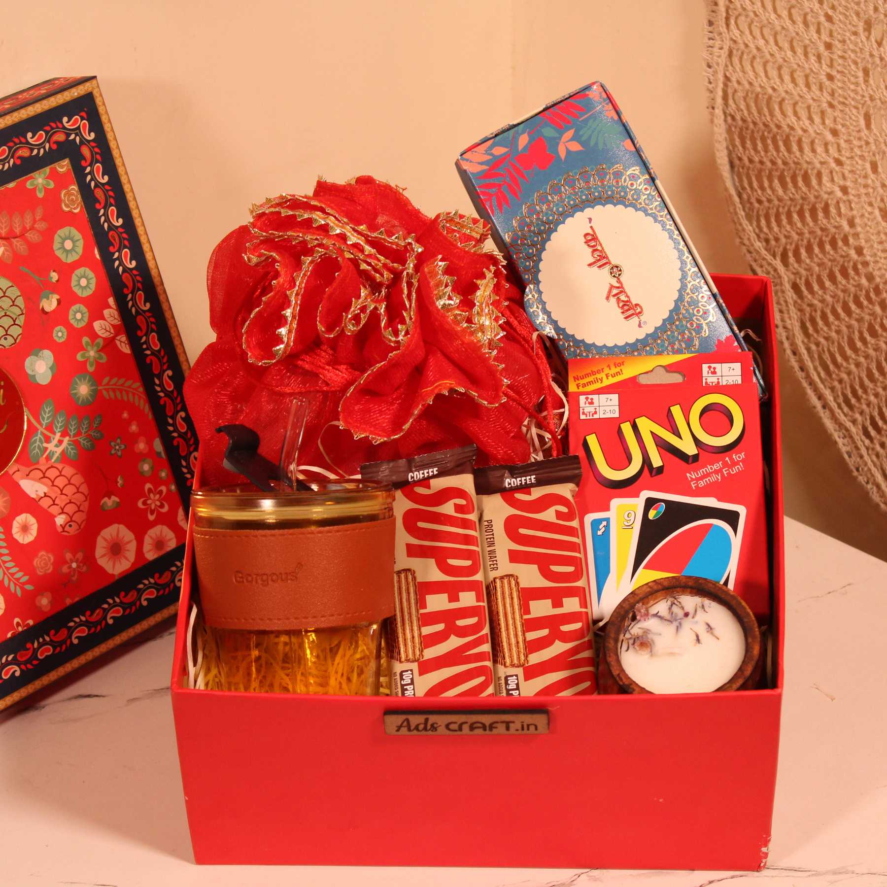 Raksha Bandhan hamper for bhai with premium rakhi, Indian potli, and festive treats.