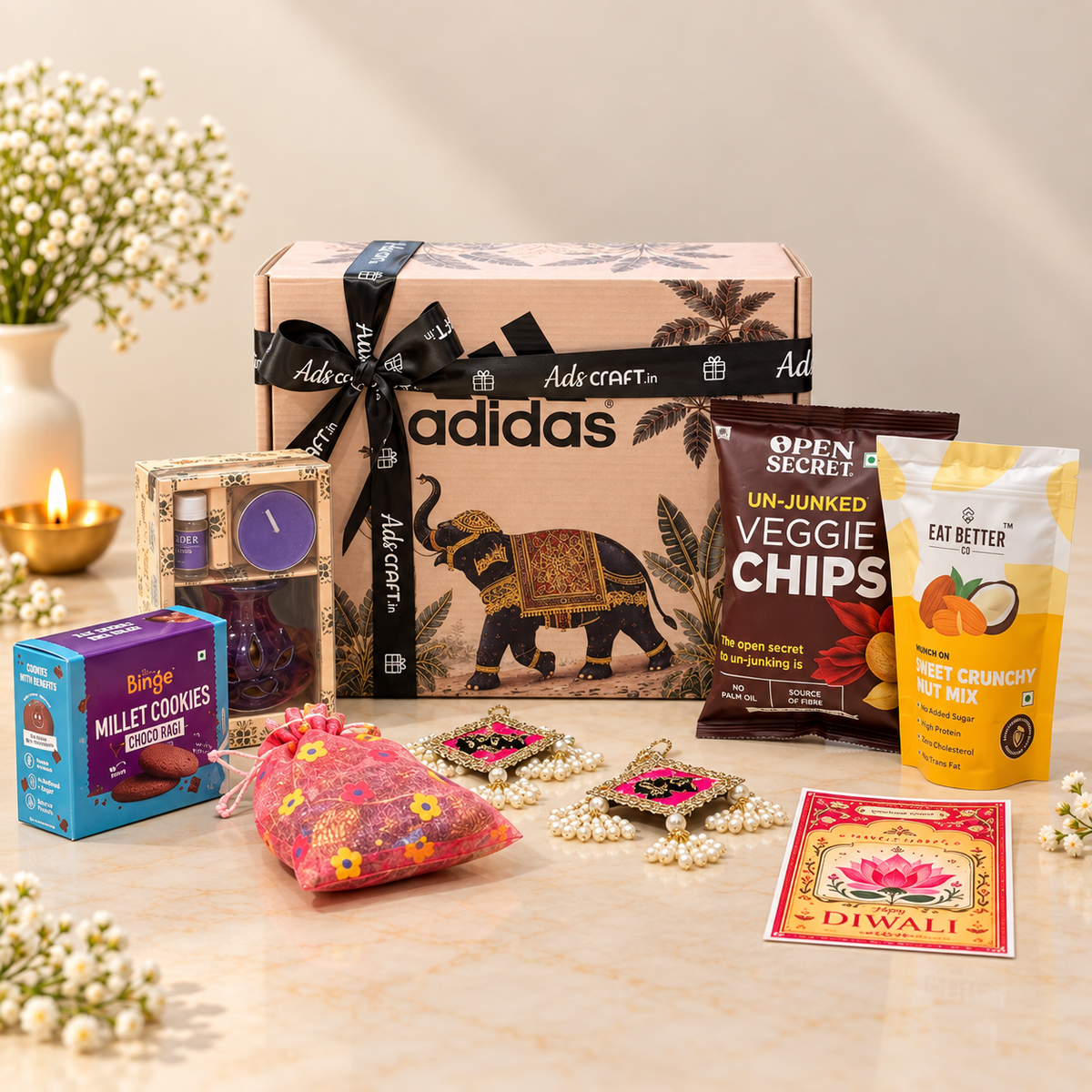 Open Gajraj Diwali gift box with veggie chips, millet cookies, crunchy nut mix, aroma diffuser and festive treats