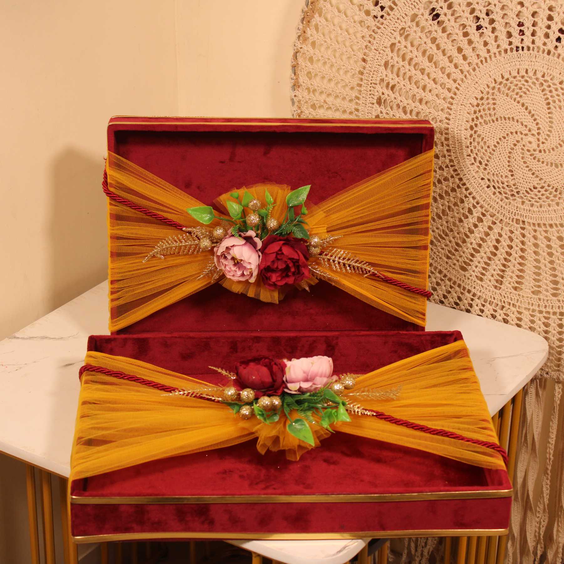 Set of 2 maroon velvet decorative gift trays with yellow net and floral decor for wedding trousseau packing